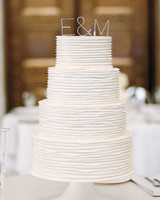 104 White Wedding Cakes That Make The Case For Going Clic Four Tiered White Wedding Cake With Layered Icing And Aluminum Initials Topper