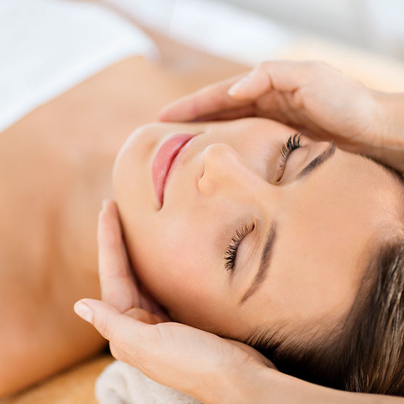 Woman receiving face massage Woman receiving face massage
