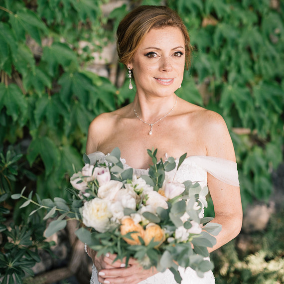 cara david wedding bride in front of greenery cara david wedding bride in front of greenery