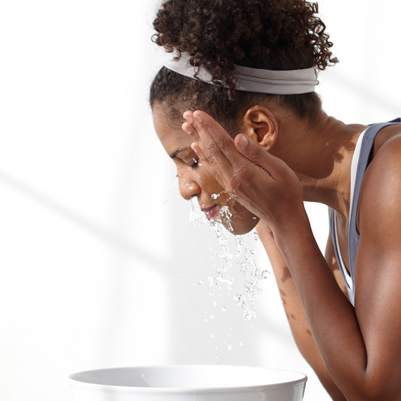 woman washing face woman washing face