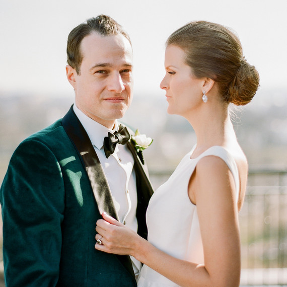 bride looks at groom while groom looks ahead for portrait photo bride looks at groom while groom looks ahead for portrait photo