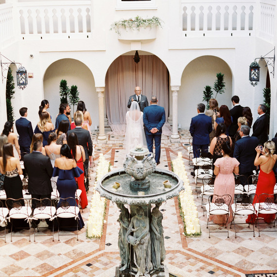 bride and groom stand at wedding alter during ceremony bride and groom stand at wedding alter during ceremony