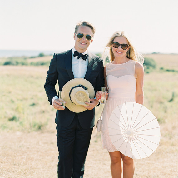 guests holding panama hats and parasols guests holding panama hats and parasols