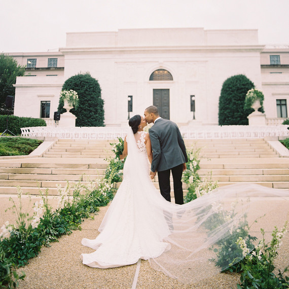 melissa justen wedding couple in front of venue kissing melissa justen wedding couple in front of venue kissing