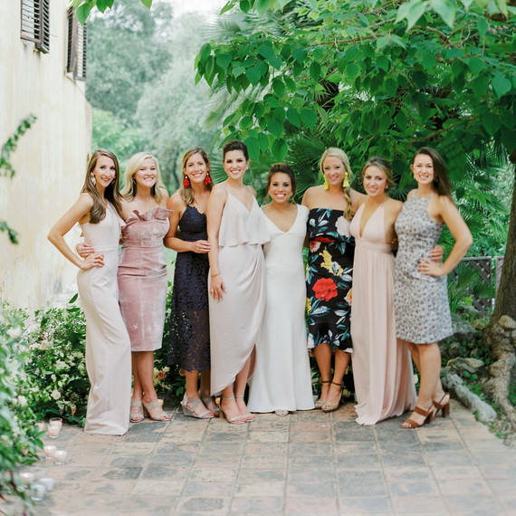 wedding guests pose with bride outdoors wedding guests pose with bride outdoors