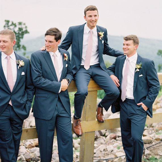 groom outdoors fence with groomsmen groom outdoors fence with groomsmen