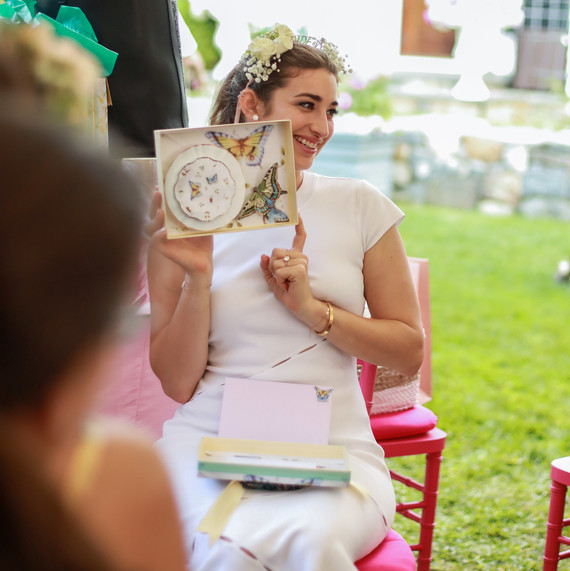bridal party bride opening butterfly gift outdoors bridal party bride opening butterfly gift outdoors