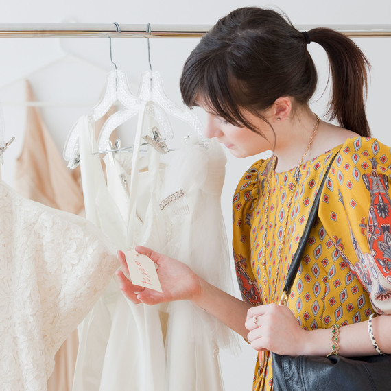 Woman Looking at Wedding Dress Price Tag Woman Looking at Wedding Dress Price Tag