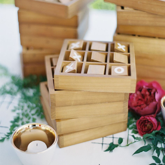 stack of tic-tac-toe wood games next to roses stack of tic-tac-toe wood games next to roses