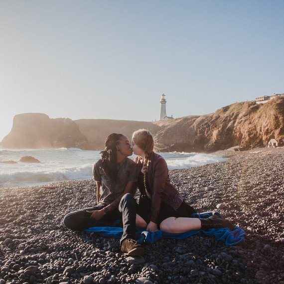 couple on rock beach engagement kiss couple on rock beach engagement kiss