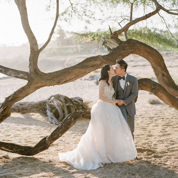 bride and groom hawaiian wedding kiss by beach tree bride and groom hawaiian wedding kiss by beach tree