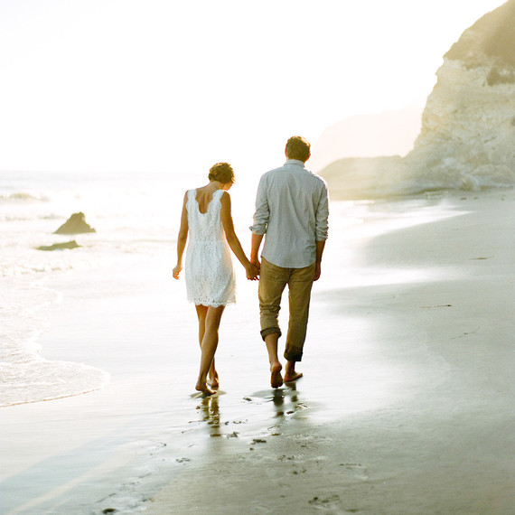 couple holding hands on beach outdoor engagement photos couple holding hands on beach outdoor engagement photos