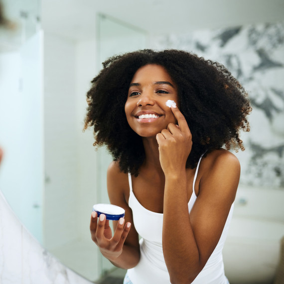Young Woman Applying Skincare Products Young Woman Applying Skincare Products