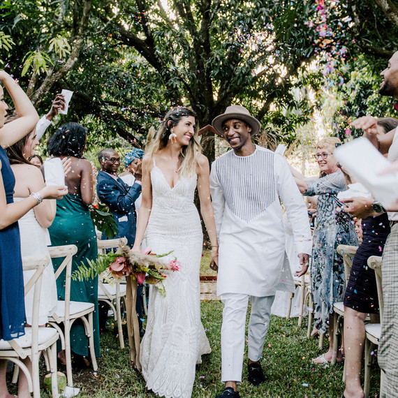 bride and groom holding hands smiling during recessional bride and groom holding hands smiling during recessional