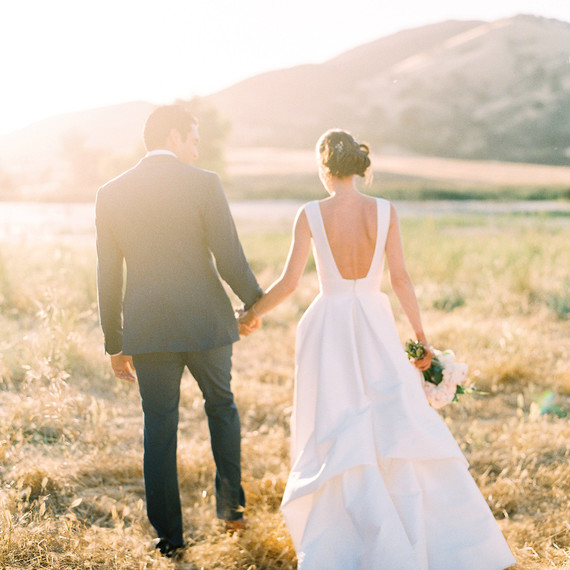 caitlin amit wedding couple walking in field caitlin amit wedding couple walking in field
