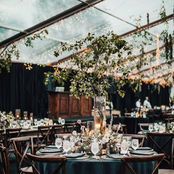 round tables with dark green linens inside glass tent reception round tables with dark green linens inside glass tent reception