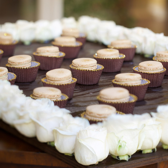 Macarons with glitter on a board with roses Macarons with glitter on a board with roses