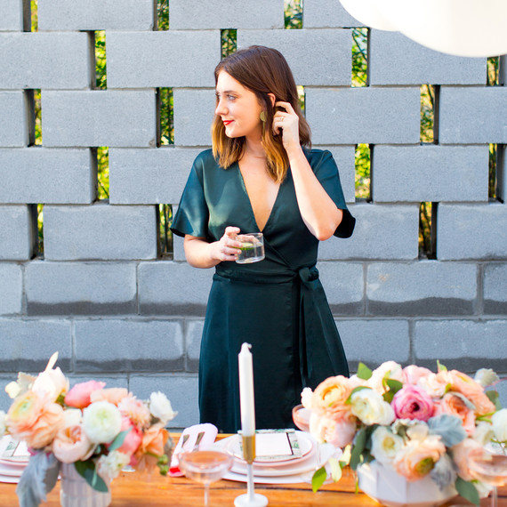 bride standing behind table bride standing behind table