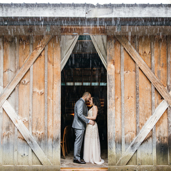 rainy wedding couple in barn rainy wedding couple in barn