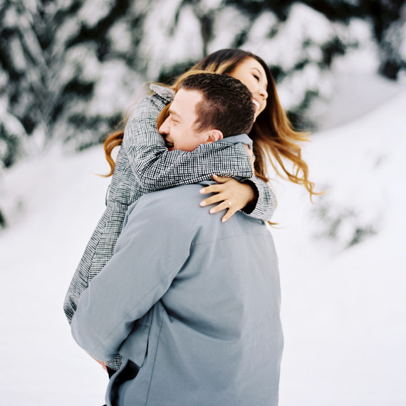 man carrying woman snow man carrying woman snow