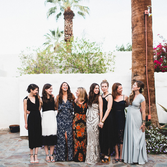 group of women in wedding guests dresses pose for photo group of women in wedding guests dresses pose for photo