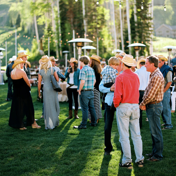 guests mingle outdoors cowboy hats guests mingle outdoors cowboy hats