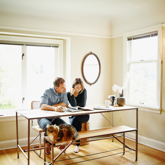 living-together-couple-at-table-reading-paper-cat-0116.jpg