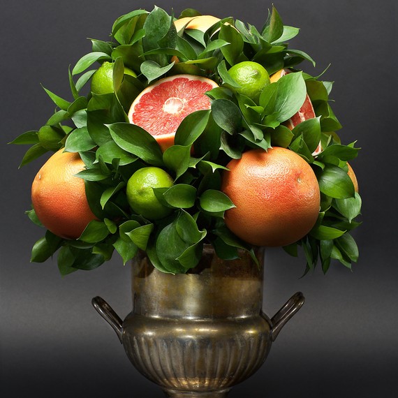 citrus centerpiece grapefruit limes leaves silver vase citrus centerpiece grapefruit limes leaves silver vase