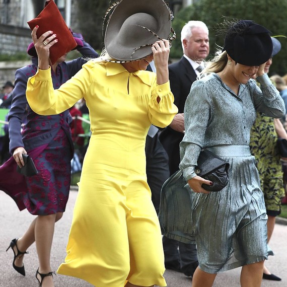 guests fight the wind as they arrive at princess eugenie's royal wedding guests fight the wind as they arrive at princess eugenie's royal wedding