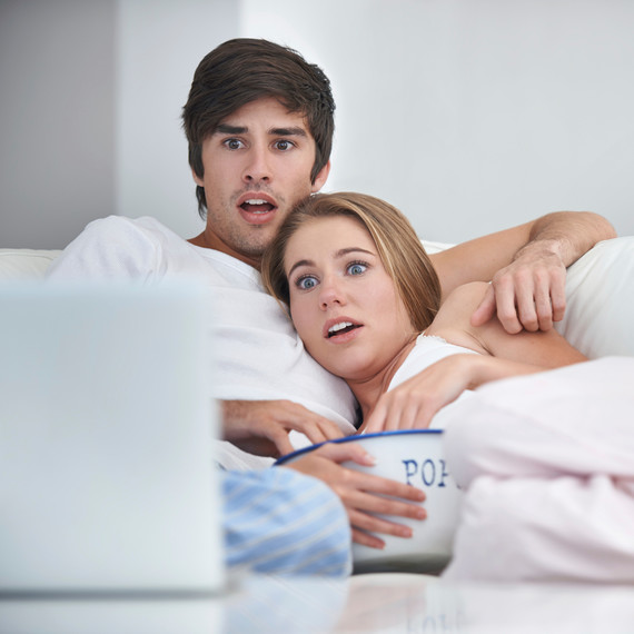 shocked-scared-couple-on-couch-watching-movie-with-popcorn-0116.jpg