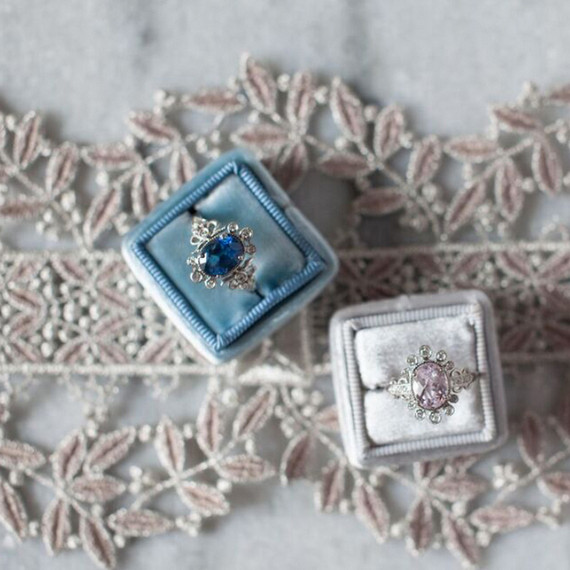 claire-pettibone-ring-collection-two-rings-in-boxes-on-lace-0915.jpg